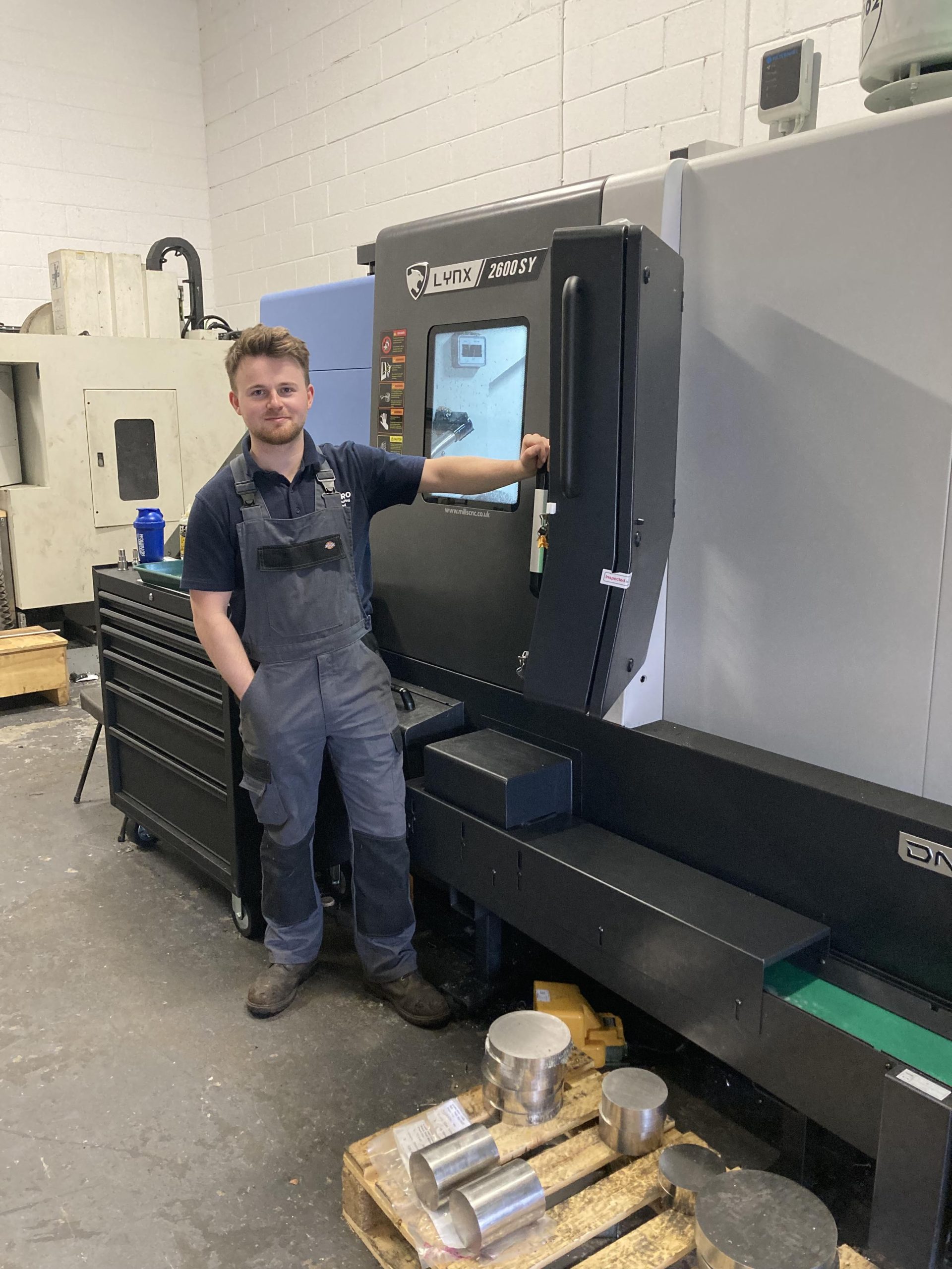 Macro Manufacturing’s owner and director, Matthew Forbes with the Fanuc-controlled DN Solutions’ sub-spindle, Y-axis Lynx 2600SY