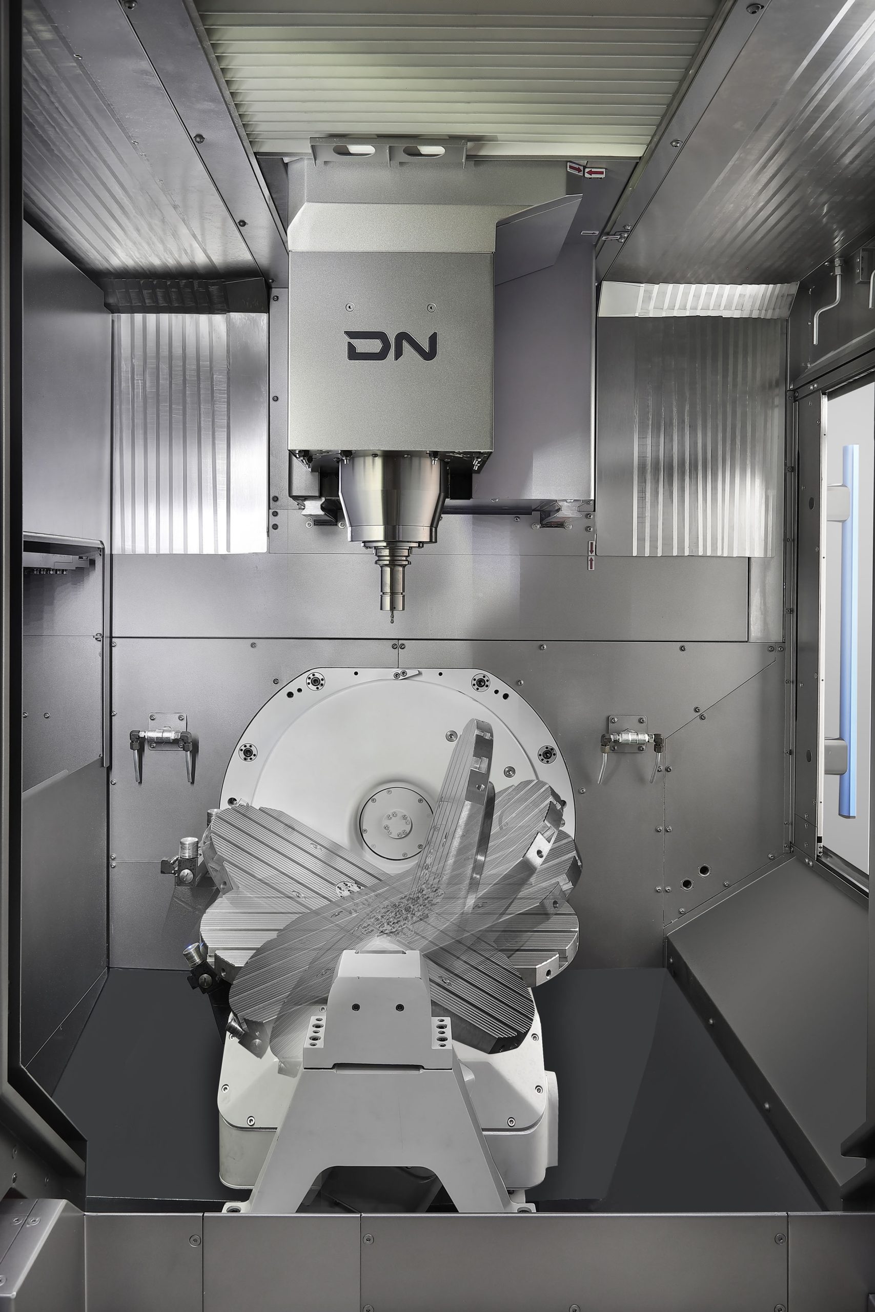 Composite image showing the tilt/turn capabilities of the new second generation DVF 5000 machining centre from DN  Solutions